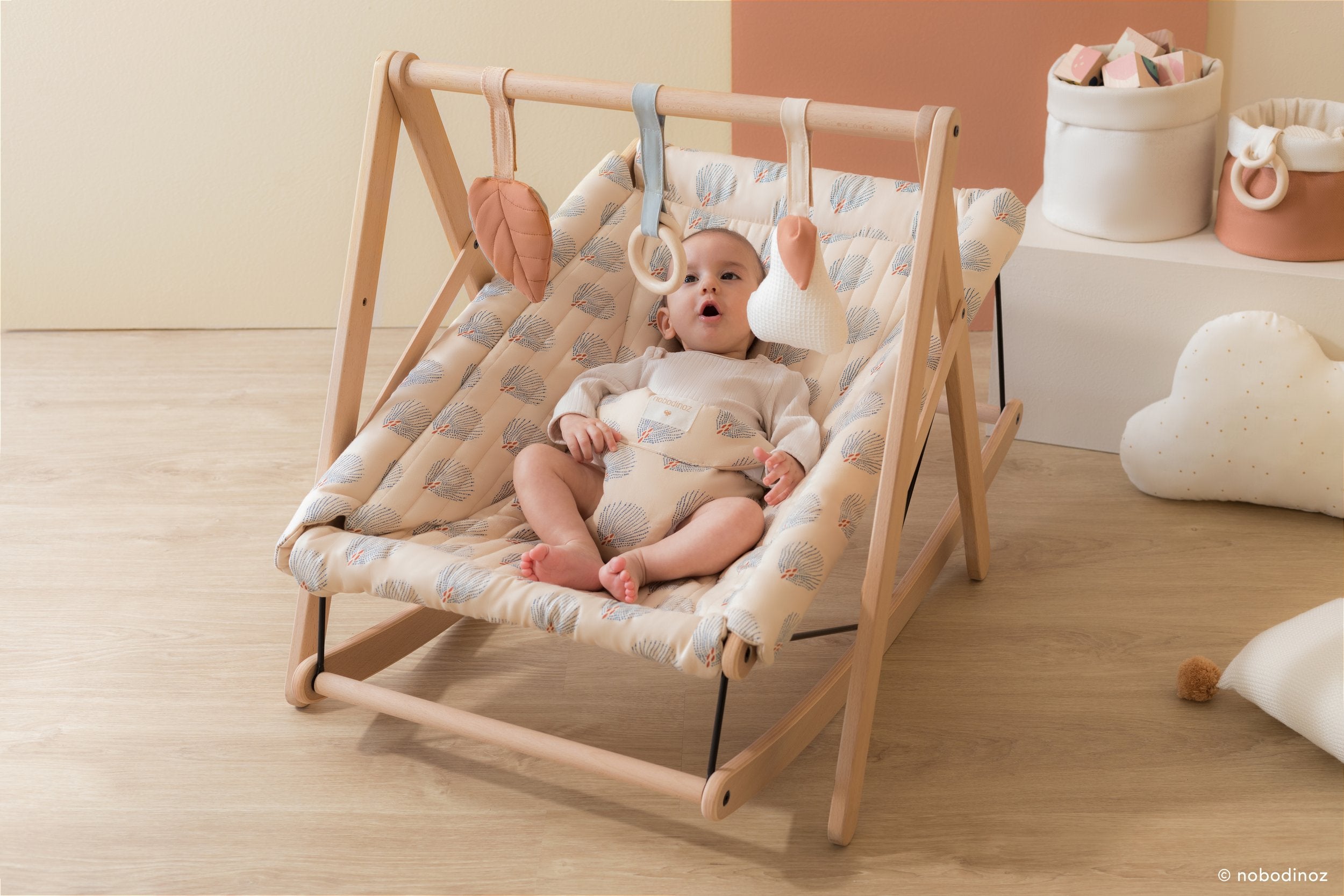 Nobodinoz Growin Green Baby Bouncer in blue gatsby cream colour with baby